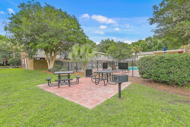 exterior space featuring a lawn, a patio, and fence