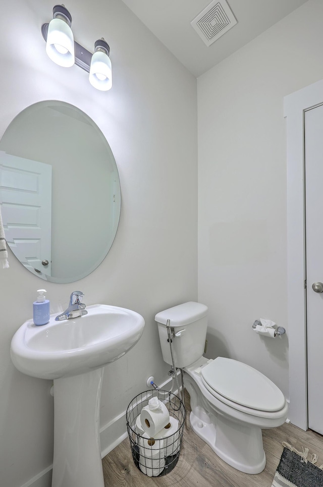 7803 Park Gate Dr, Charleston, SC 29418 - bathroom featuring toilet, visible vents, wood finished floors, and baseboards