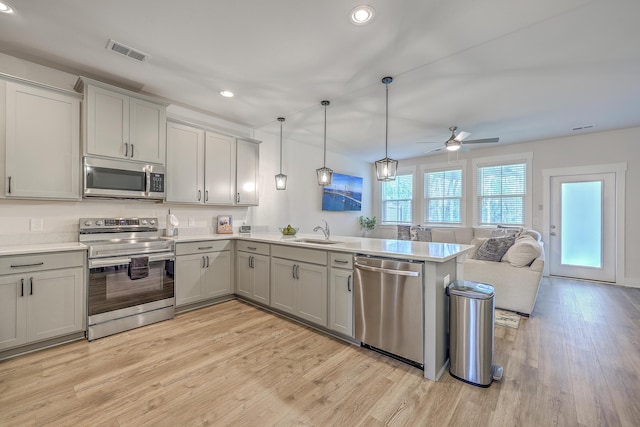 7803 Park Gate Dr, Charleston, SC 29418 - kitchen with a sink, appliances with stainless steel finishes, a peninsula, gray cabinetry, and visible vents