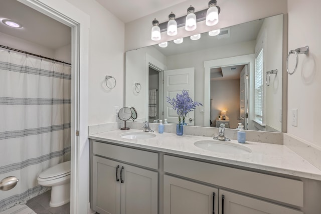 7803 Park Gate Dr, Charleston, SC 29418 - bathroom with double vanity, a sink, toilet, and tile patterned floors