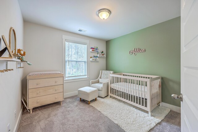 7803 Park Gate Dr, Charleston, SC 29418 - bedroom with carpet flooring, a nursery area, baseboards, and visible vents