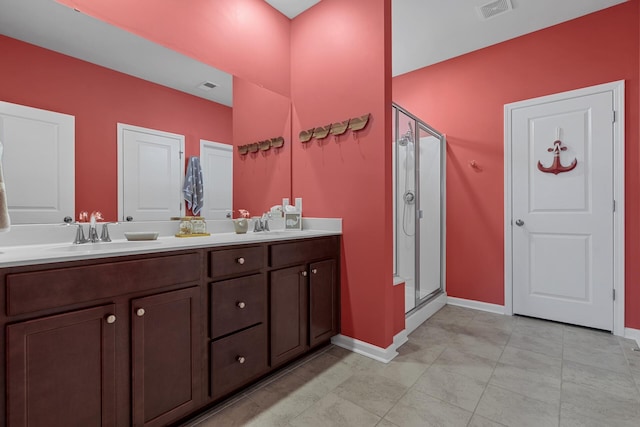 bathroom featuring vanity and a shower with shower door