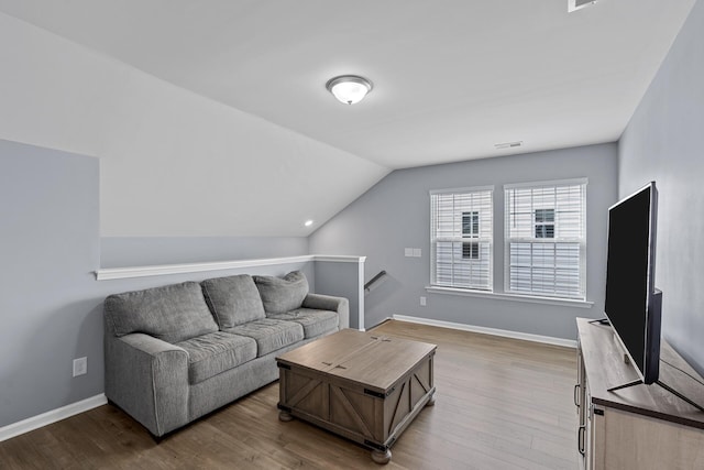 living room with light hardwood / wood-style floors and lofted ceiling