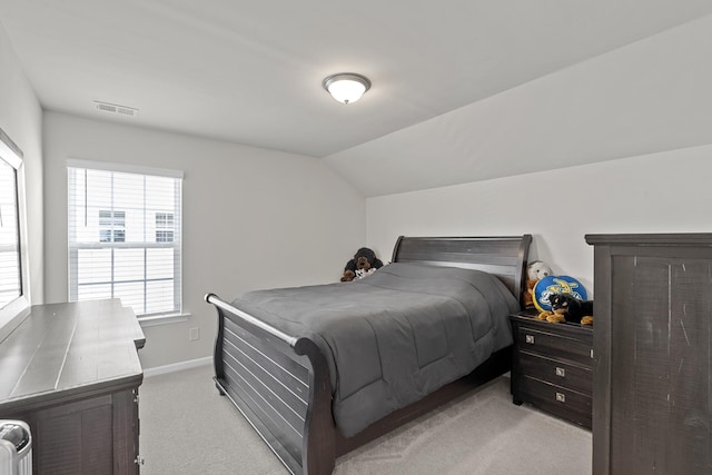 bedroom with light carpet and vaulted ceiling