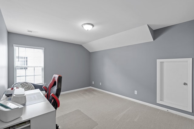 office featuring light carpet and vaulted ceiling