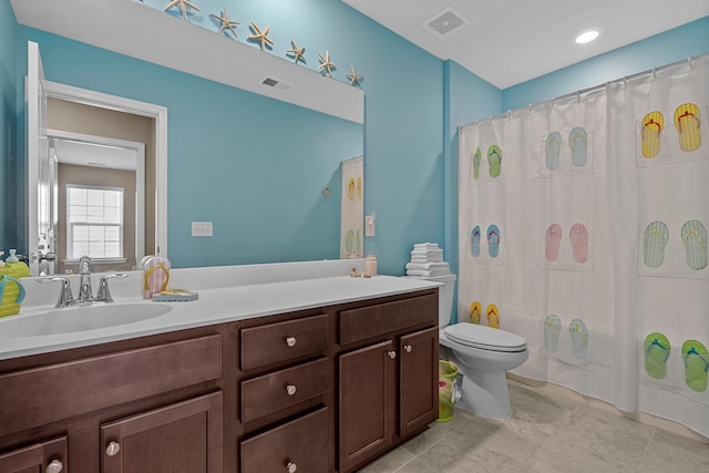 bathroom featuring tile patterned floors, vanity, and toilet