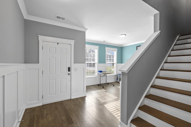 entryway with wood-type flooring and ornamental molding