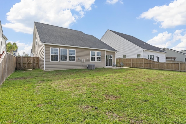 rear view of property with a yard, a patio, and central AC unit