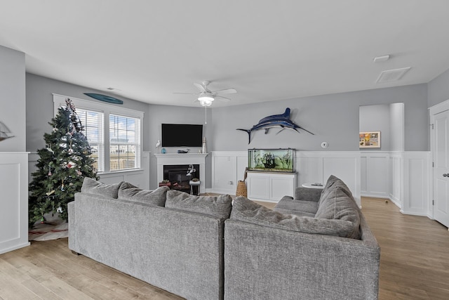 living room featuring ceiling fan and light wood-type flooring