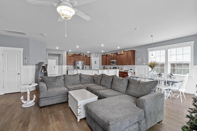 living room with ceiling fan and hardwood / wood-style flooring