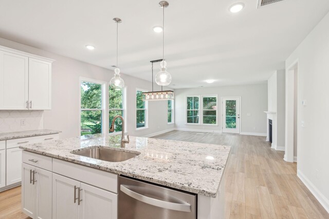 kitchen with white cabinets, sink, light hardwood / wood-style flooring, and dishwasher