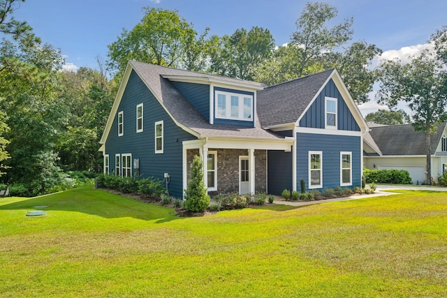 view of front of house with stone siding, roof with shingles, board and batten siding, and a front yard