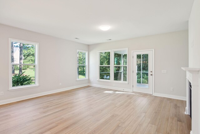 unfurnished living room with light hardwood / wood-style flooring