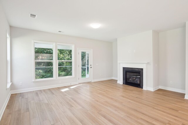 unfurnished living room with light hardwood / wood-style flooring