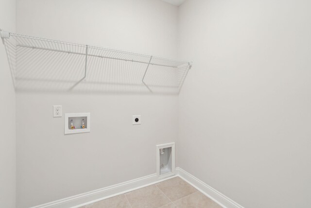 laundry area featuring hookup for a washing machine, electric dryer hookup, and light tile patterned flooring