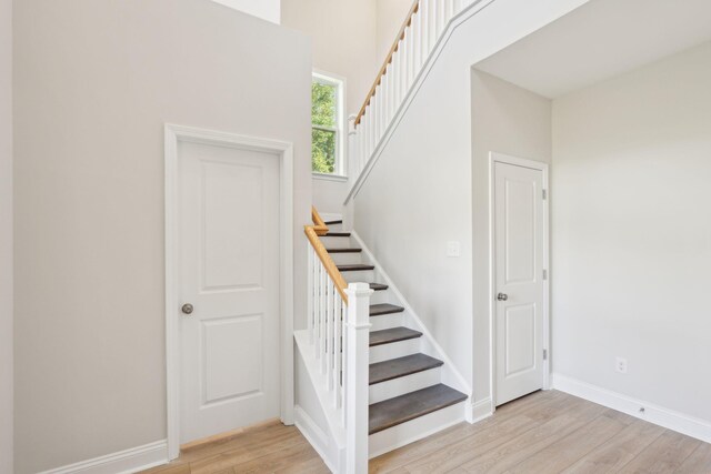 stairs featuring hardwood / wood-style floors