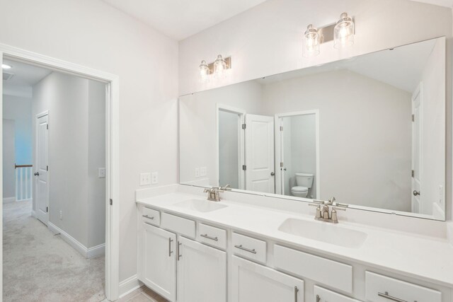 bathroom featuring toilet and vanity