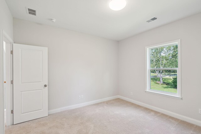 unfurnished room with light colored carpet