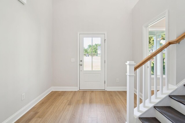 foyer entrance with light hardwood / wood-style floors and plenty of natural light