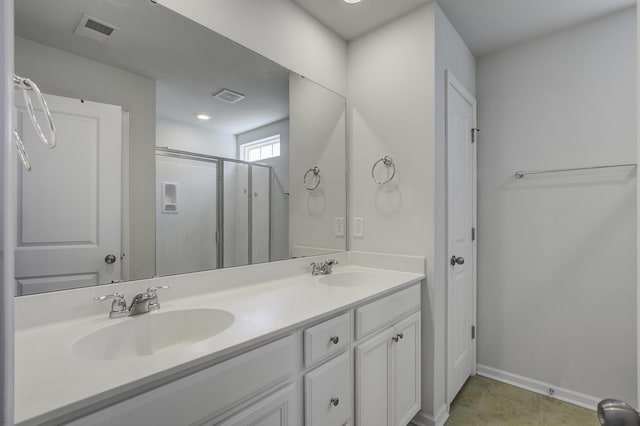 full bath featuring double vanity, a stall shower, visible vents, and a sink