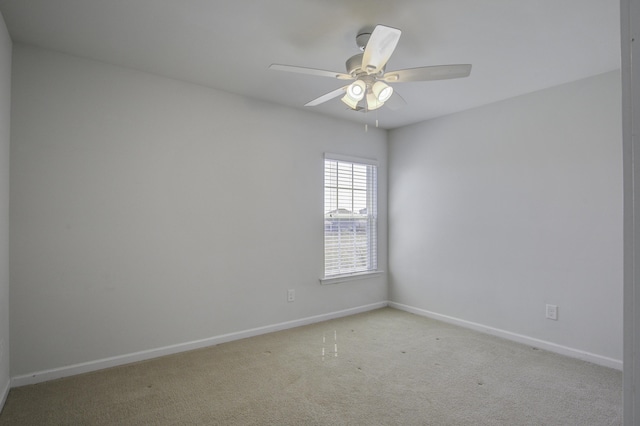 unfurnished room featuring carpet flooring, ceiling fan, and baseboards