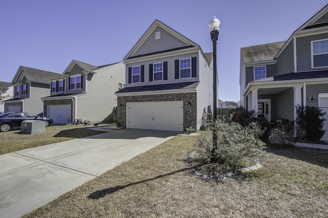 traditional-style home with brick siding, an attached garage, and concrete driveway