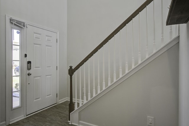 foyer entrance with dark wood finished floors and stairs