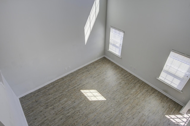 empty room featuring baseboards and wood finished floors