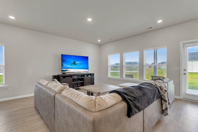 living room featuring recessed lighting, light wood-style floors, visible vents, and baseboards