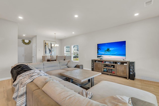 living room with light wood finished floors, visible vents, and recessed lighting