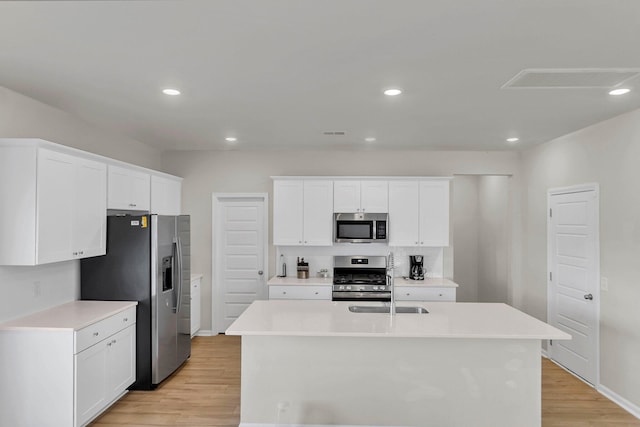 kitchen with light countertops, recessed lighting, light wood-style floors, and appliances with stainless steel finishes