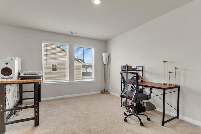 carpeted home office featuring visible vents and baseboards