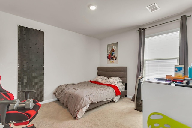 bedroom featuring light colored carpet, visible vents, and baseboards