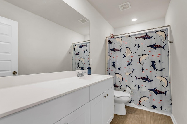 bathroom featuring visible vents, toilet, vanity, and a shower with shower curtain