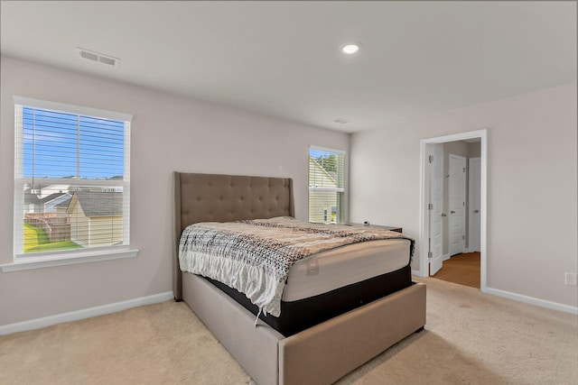 bedroom with recessed lighting, light colored carpet, visible vents, and baseboards