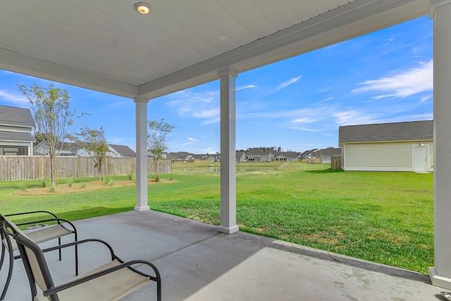 view of patio with a residential view and fence