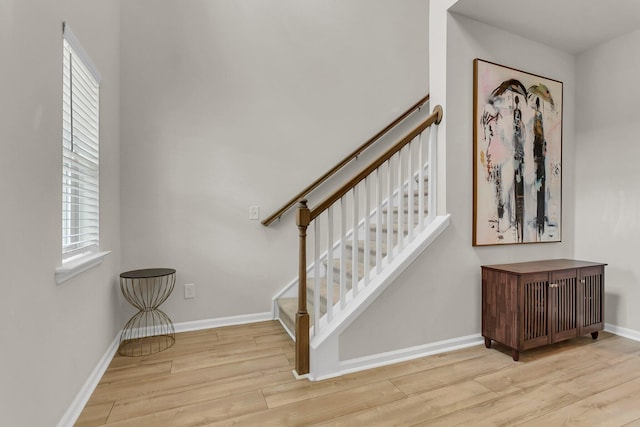 stairs featuring baseboards and wood finished floors