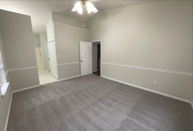 unfurnished bedroom featuring ceiling fan, carpet, and high vaulted ceiling