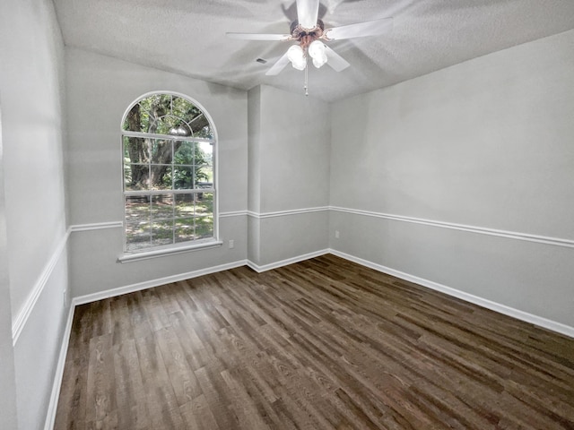 empty room featuring a textured ceiling, ceiling fan, and dark hardwood / wood-style floors