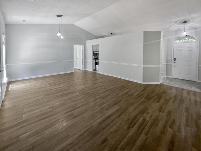 unfurnished living room with dark wood-type flooring and lofted ceiling