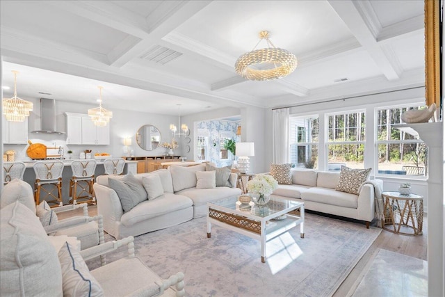 living room with coffered ceiling, a chandelier, beam ceiling, and light hardwood / wood-style flooring