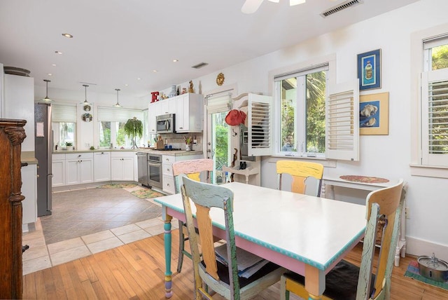 dining space with recessed lighting and light wood-style floors