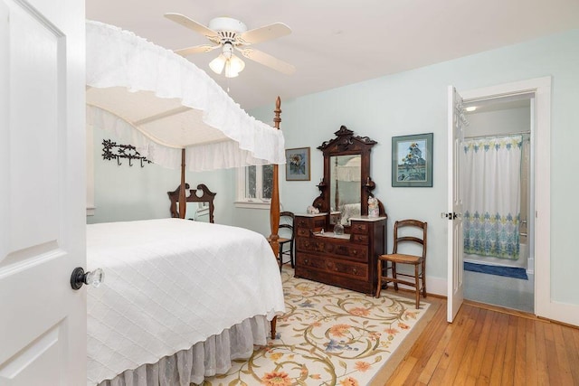 bedroom featuring wood-type flooring, a ceiling fan, and baseboards