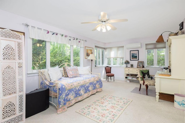carpeted bedroom featuring a wall mounted AC and a ceiling fan
