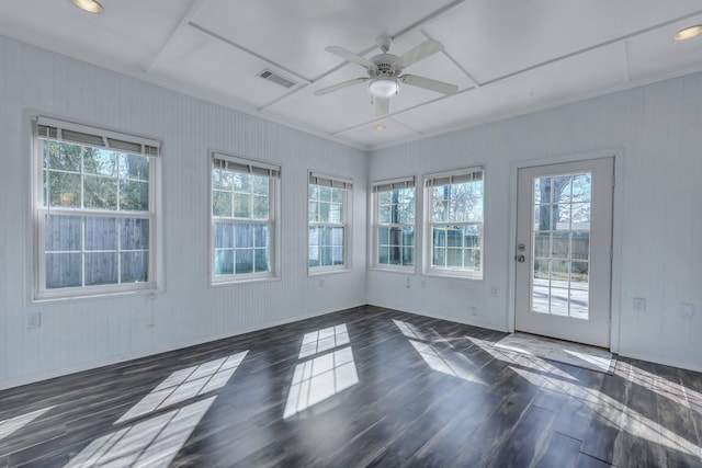 spare room featuring a healthy amount of sunlight, dark hardwood / wood-style floors, and ceiling fan