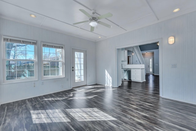 empty room featuring crown molding, dark hardwood / wood-style floors, and ceiling fan