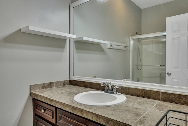 bathroom featuring vanity and a shower with shower door