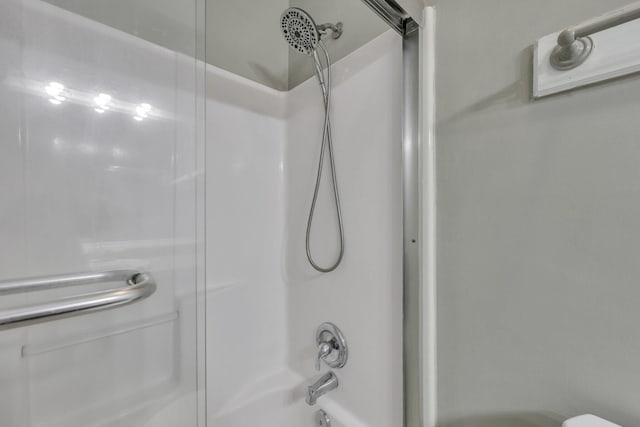 bathroom featuring toilet and bathing tub / shower combination