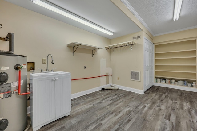 washroom featuring sink, a textured ceiling, ornamental molding, hookup for an electric dryer, and water heater