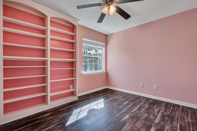 unfurnished room with ceiling fan, dark hardwood / wood-style floors, and a textured ceiling